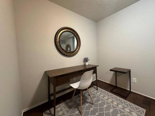 a desk with a chair and a mirror on a wall at Cozy townhome in The Woodlands in The Woodlands