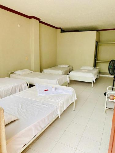 a room with four beds in a room at Club Vacacional COPEN in Tocaima
