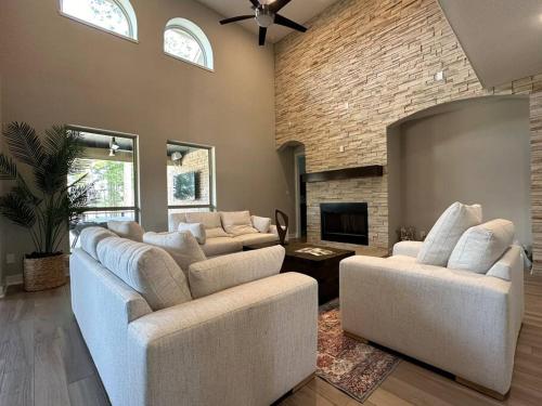 a living room with two couches and a fireplace at Luxury Home in The Woodlands in The Woodlands