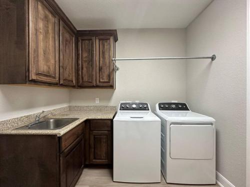 a small kitchen with a stove and a sink at Luxury Home in The Woodlands in The Woodlands