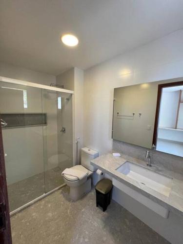 a bathroom with a toilet and a sink and a shower at Apartamento Morro do Careca in Natal