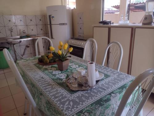 a kitchen with a table with a table cloth on it at Casa em Praia de Alter do Chão in Santarém