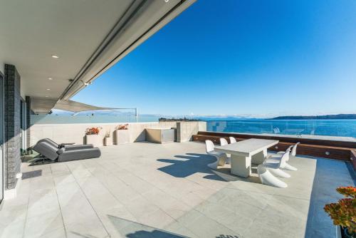a patio with a view of the water at Sacred Waters Taupo in Taupo
