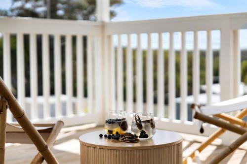 a pair of glasses sitting on a table on a porch at YARLU by Silver Sands in Aldinga Beach