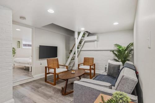 a living room with a couch and a tv at Garden-Level 2-BR Apt in Historic Petworth Home in Washington, D.C.