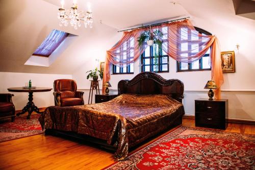 a bedroom with a bed and a large window at Antique House Hotel in Dubno