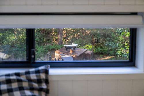 a window view of a table with a bowl on it at Krishna Farm Retreat in Coolabine