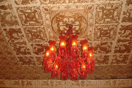 a chandelier hanging from a ceiling in a room at The Red House in Ooty