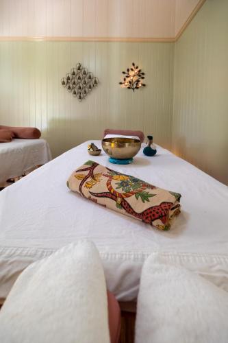 a white table with a bowl on top of it at Krishna Farm Retreat in Coolabine