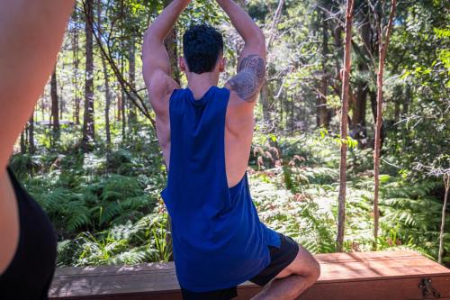 a man doing a yoga pose in the woods at Krishna Farm Retreat in Coolabine