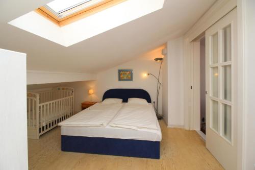 a bedroom with a bed and a skylight at Apartment Klepac in Punat