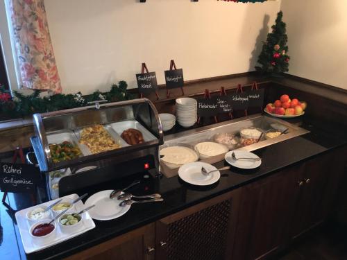 a buffet line with food on a table at Hotel BB Bahnhof Bertsdorf in Olbersdorf