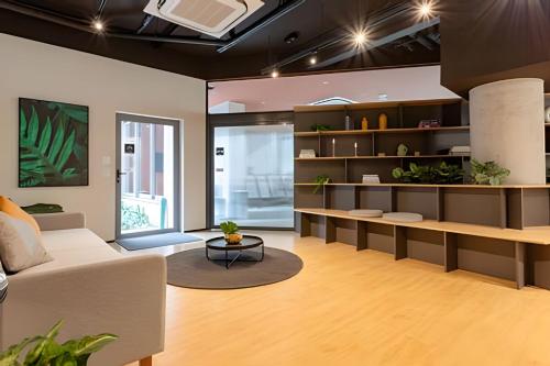 a living room with a couch and a table at Nik Perdizes in Sao Paulo