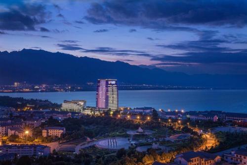 a view of a city at night with the water at Dali Hotel in Dali