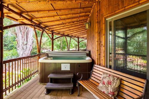 a sauna on a wooden deck with a bench on a porch at Hawaiian Dream Temple in Kaupakulua