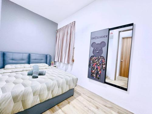a bedroom with a bed and a picture on the wall at Hanns modern paradise in Sibu