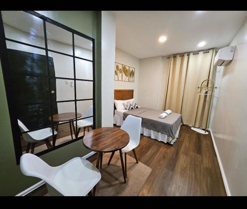 a room with a bed and a table and chairs at A & G Lodge in Mameltac