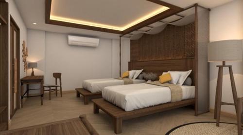 a bedroom with two beds and a table and a desk at Railay Bay Resort & Spa in Railay Beach
