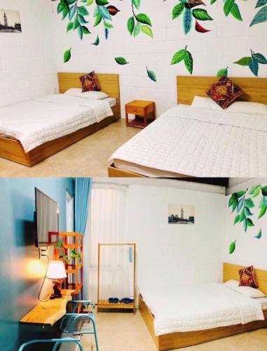a bedroom with two beds with leaves on the wall at Jrai Homestay in Pleiku