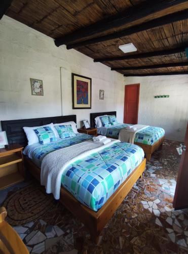 a bedroom with two beds in a room at Finca San Alejandro in Cotacachi