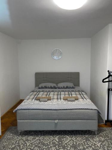 a bed in a bedroom with a white wall at Panorama Royal Vračar in Vračar (historical)