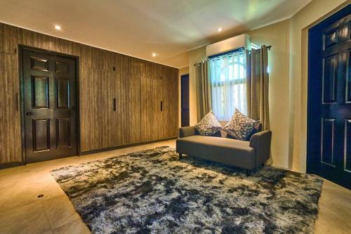 a living room with a couch and a rug at Dos Maya by Araw Residences in Nasugbu