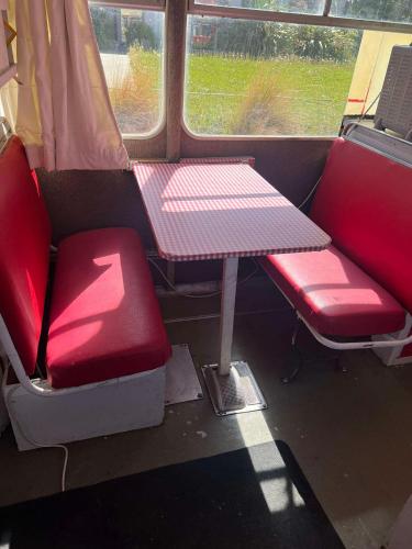 a table and two chairs in a train car at Decker Daze Queenstown in Queenstown