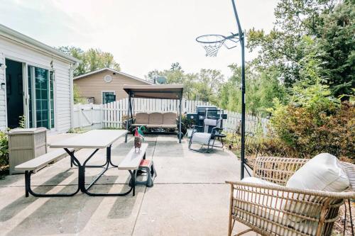 a patio with a table and a basketball hoop at Cozy 4BR Home with 2by5 Baths in Schaumburg