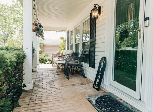a porch with chairs and a sign on a house at Cozy 4BR Home with 2by5 Baths in Schaumburg