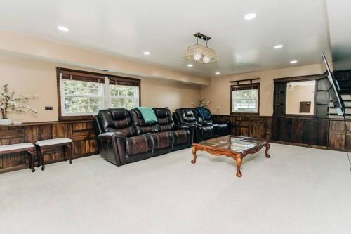 a living room with a couch and a coffee table at Cozy 4BR Home with 2by5 Baths in Schaumburg