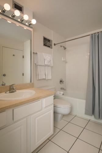 a white bathroom with a sink and a toilet at Evergreen Lodge at Vail in Vail