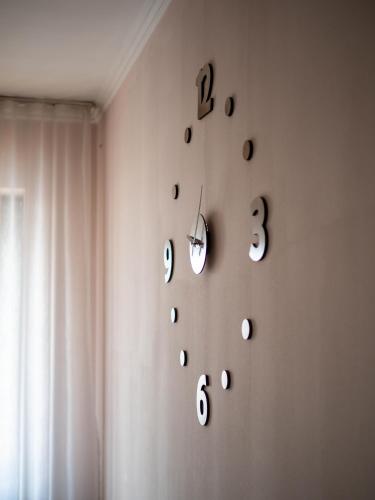a room with a wall with clocks on the wall at Appartments " Zhetysu-4" in Almaty