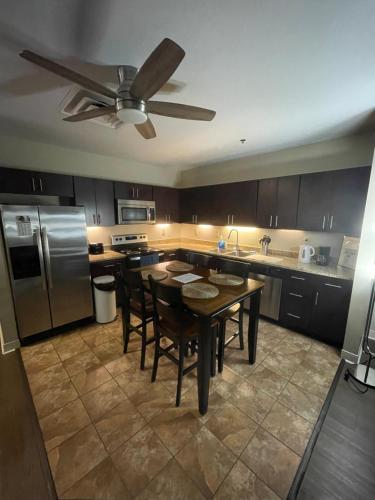 a kitchen with a table and a ceiling fan at Luxury Apt at the Point Easy Access To and From Downtown 24-7 Parking in Pittsburgh