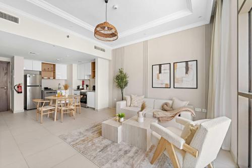 a living room with a couch and a table at Silkhaus Vacation Homes Chic and Cozy 1 BR Nearby Reem Park in Abu Dhabi