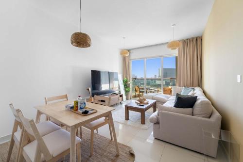 a living room with a couch and a table at Silkhaus Vacation Homes Cozy 1BDR Near Reem Mall in Burooj Views in Abu Dhabi
