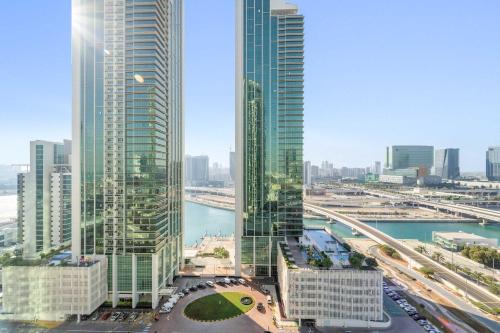a view of a city with tall skyscrapers at Silkhaus Vacation Homes Cozy 1BDR Near Reem Mall in Burooj Views in Abu Dhabi