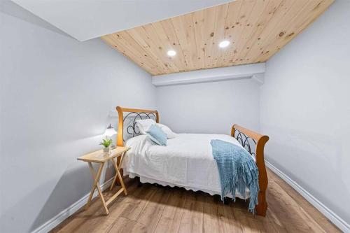 a bedroom with a bed and a wooden ceiling at Ultimate Lakeview Retreat - Hot Tub, Paddle & Play in Bancroft