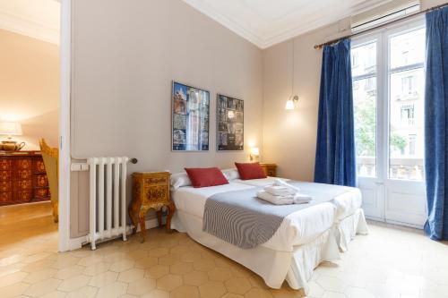 a bedroom with a bed and a large window at AinB B&B Born-Via Laietana in Barcelona
