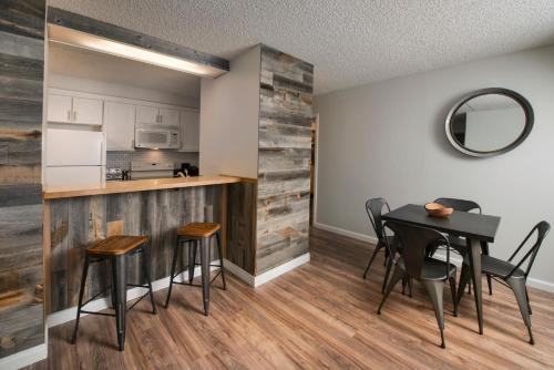 a kitchen and dining room with a table and chairs at Evergreen Lodge at Vail in Vail