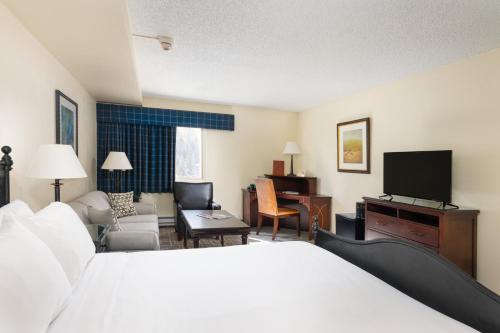 a hotel room with a bed and a television at Evergreen Lodge at Vail in Vail