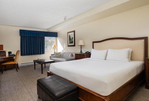 a hotel room with a large bed and a desk at Evergreen Lodge at Vail in Vail