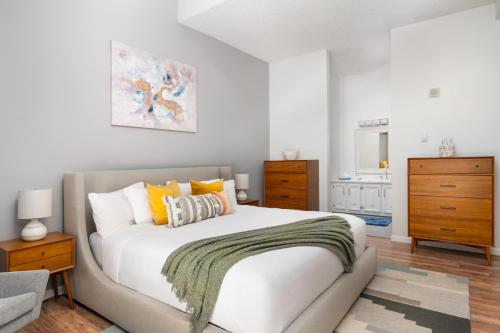 a bedroom with a large white bed with yellow pillows at Evergreen Lodge at Vail in Vail