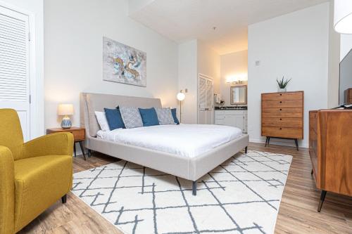 a bedroom with a bed and a yellow chair at Evergreen Lodge at Vail in Vail