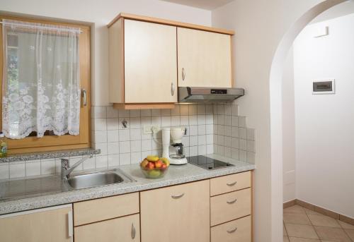 a kitchen with a sink and a counter top at Kampflhof Apartments in Schenna