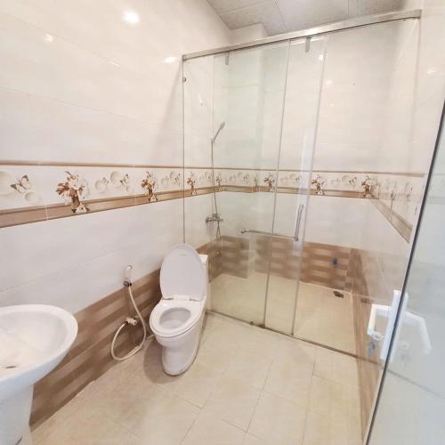 a bathroom with a shower and a toilet and a sink at Homestay Đức Thạnh in Rạch Giá