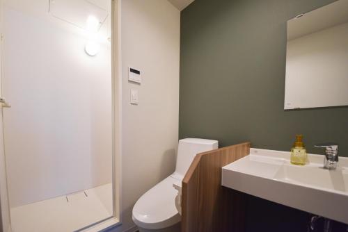 a bathroom with a white toilet and a sink at Setolive by 4S STAY in Takamatsu