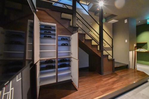 a room with a staircase and a wine cellar at Setolive by 4S STAY in Takamatsu