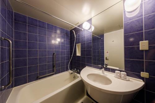 a bathroom with a tub and a sink and a mirror at Shinagawa Prince Hotel in Tokyo