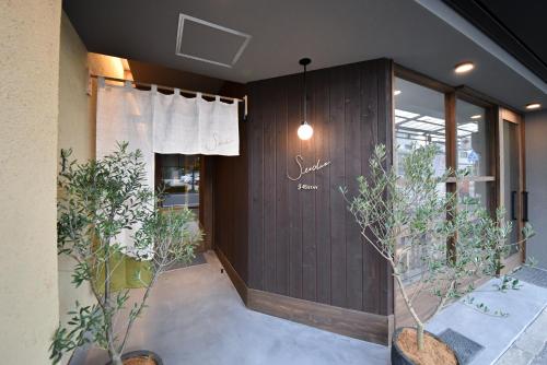 a lobby with plants in front of a building at Setolive by 4S STAY in Takamatsu