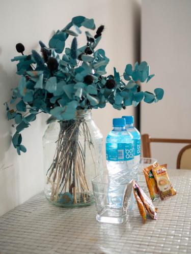 a vase with flowers in it on a table at Appartments " Zhetysu-4" in Almaty